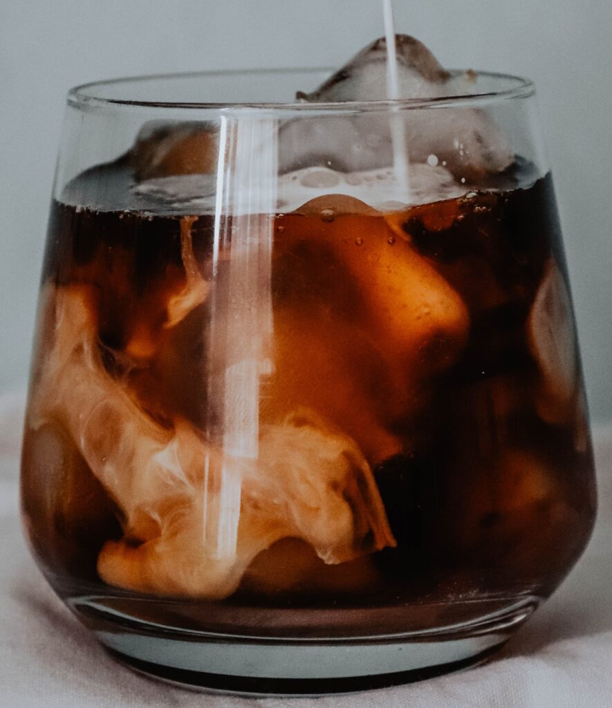 A glass of iced cortado coffee