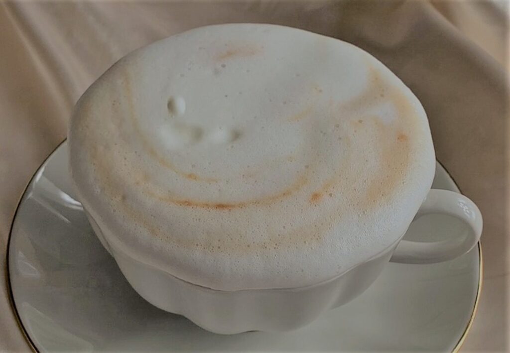a cup of bone dry cappuccino is ready to drink