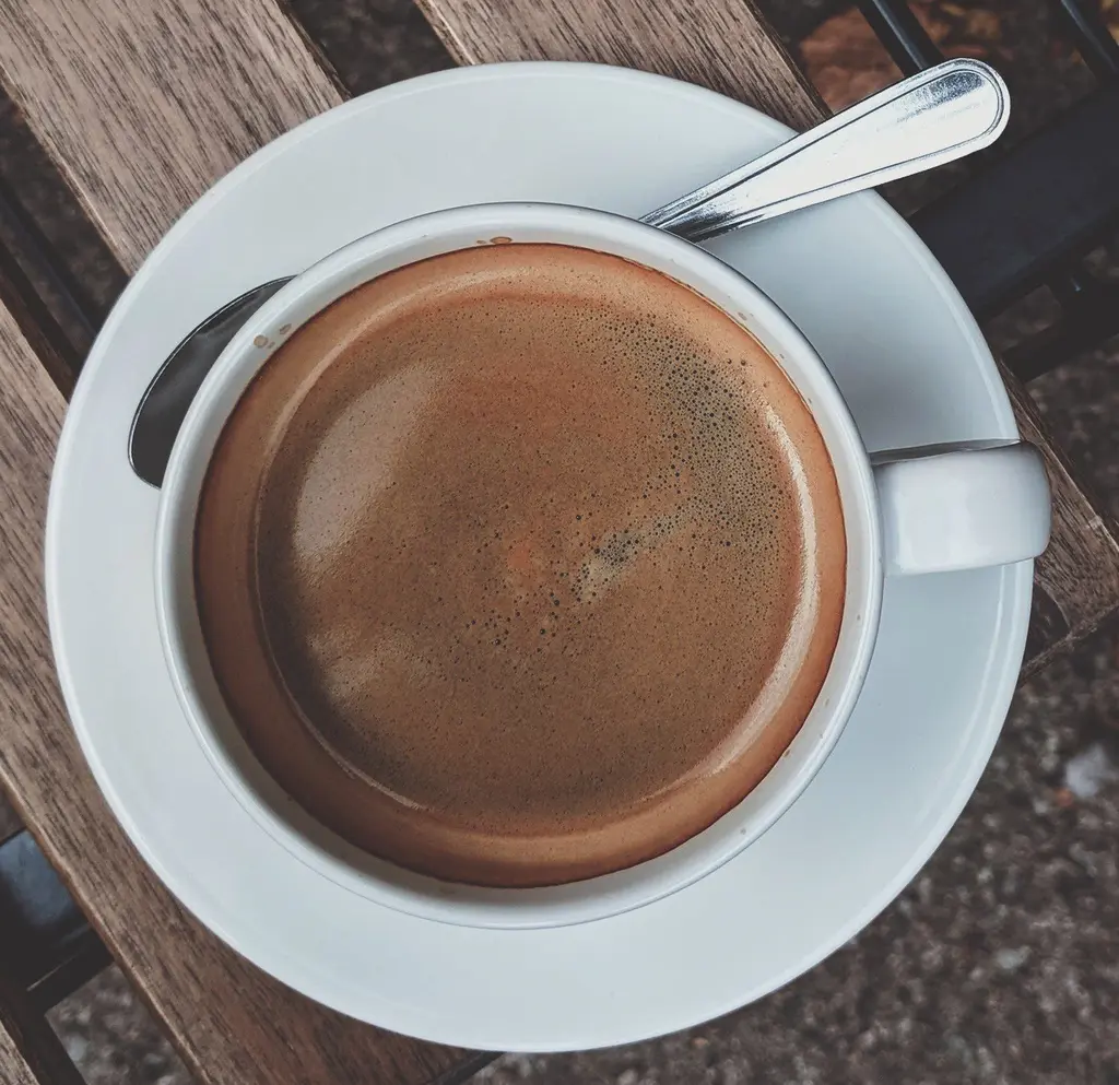 a cup of espresso topping with crema