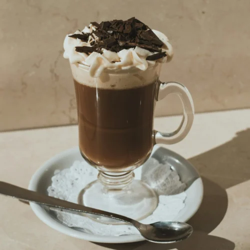 A glass of Irish cream breve consists of espresso, half & half, and Irish syrup.
