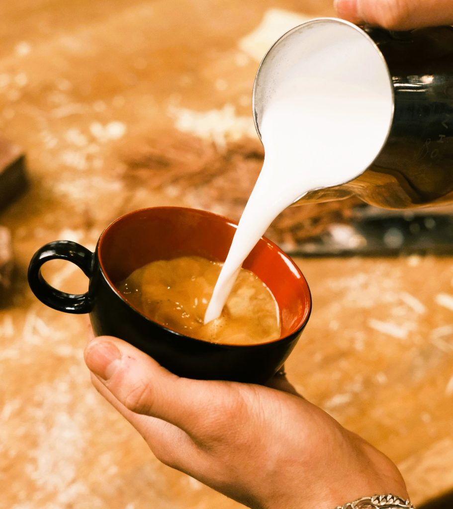 adding cream to espresso
