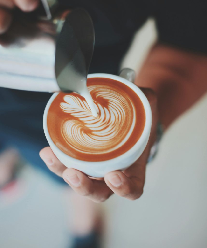adding milk to latte