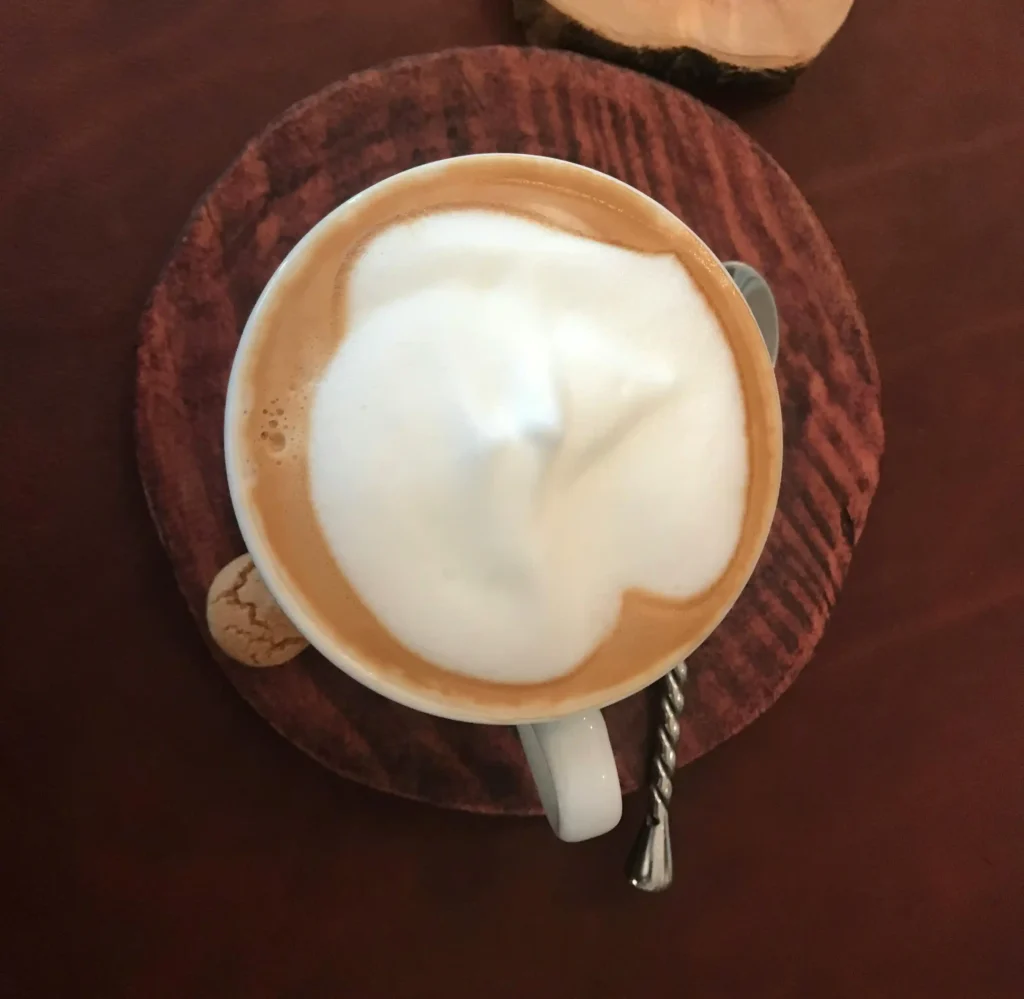 a small cup of creamy caffe macchiato