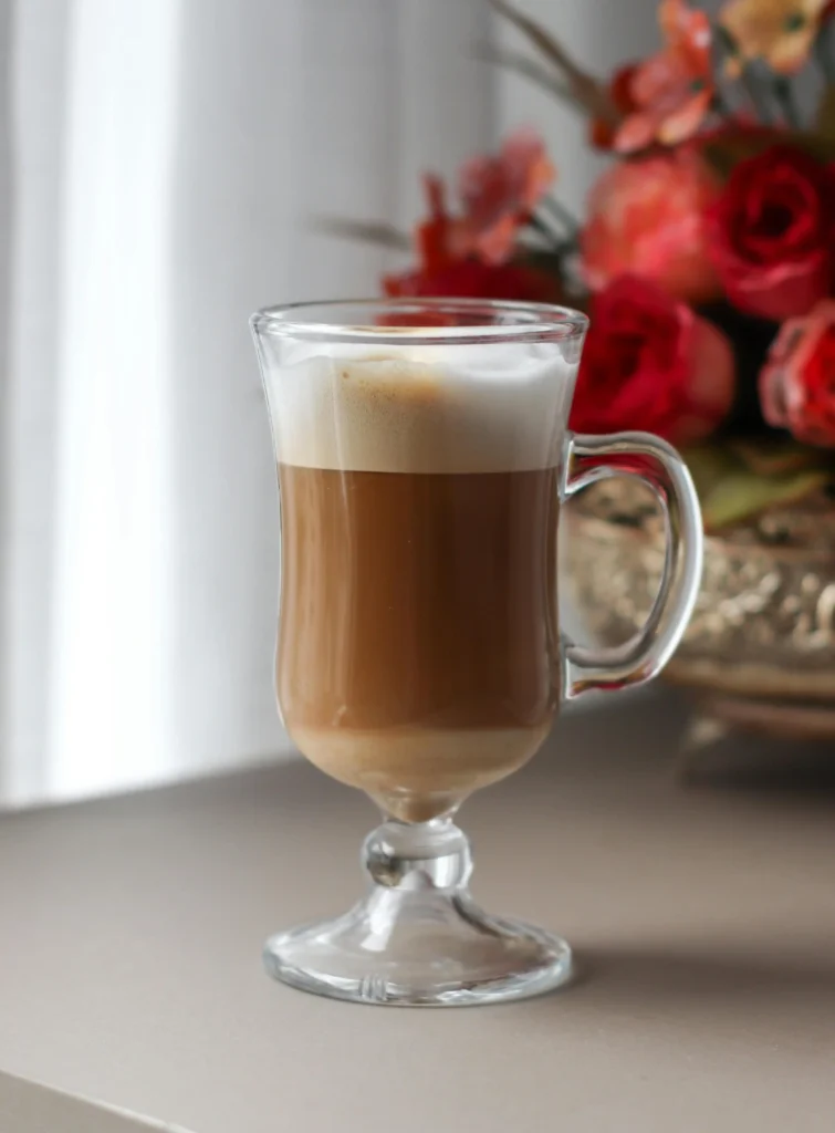 A large glass of creamy latte Macchiato prepared with espresso and steamed milk, 