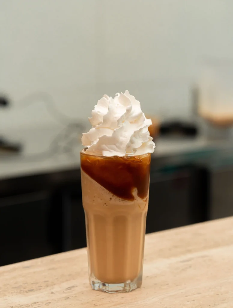 A coffee cup is made with whipped cream on top